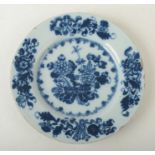 A Delft blue and white tin glazed plate, 18th century, decorated with a bowl of flowers,