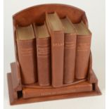 A Fortnum & Mason Ltd, London brown leather desk library, complete with six books, height 21cm,