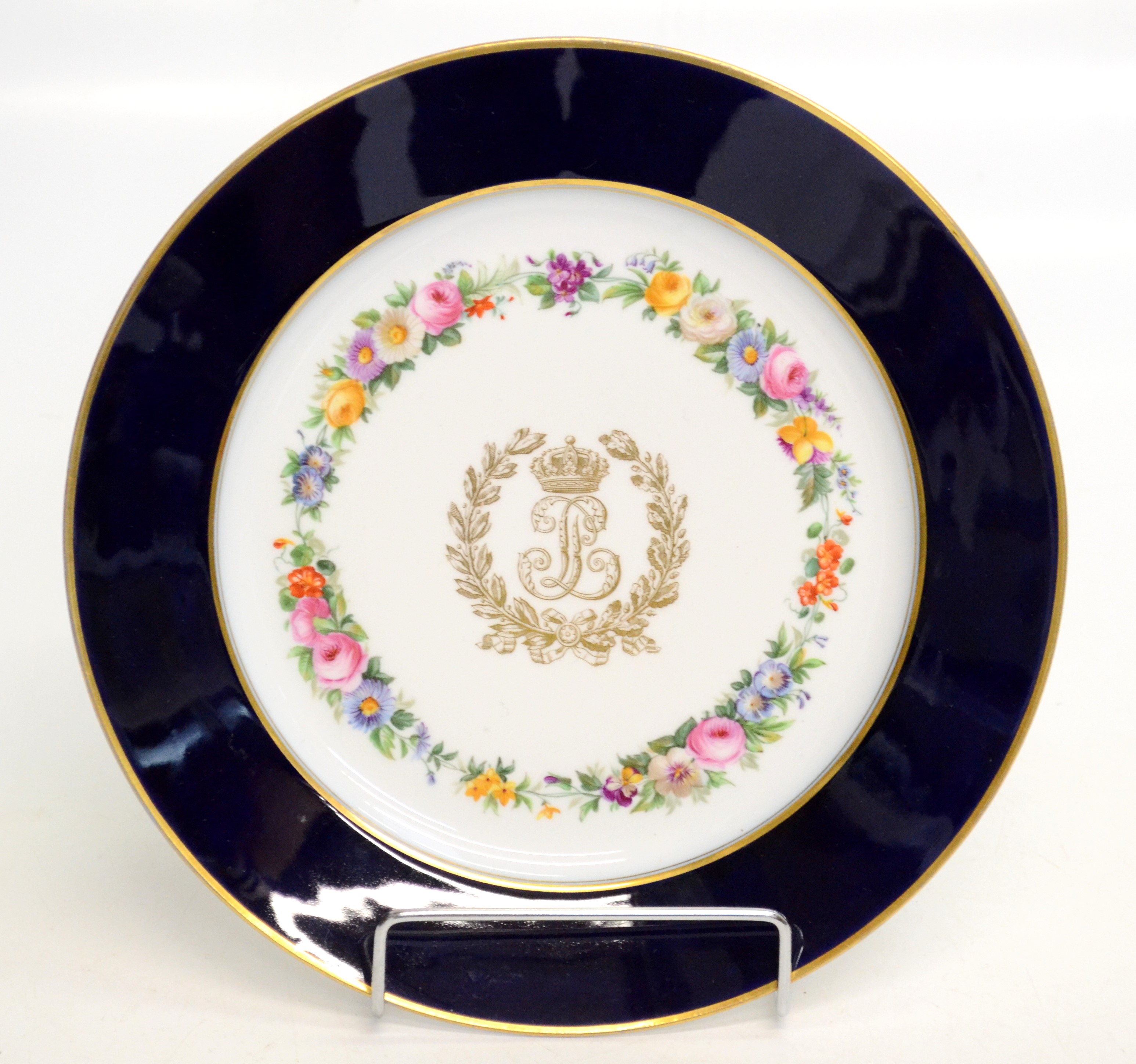 A Sevres plate with the monogram of Louis-Philippe within an enamel flower band and blue and gilt
