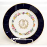A Sevres plate with the monogram of Louis-Philippe within an enamel flower band and blue and gilt