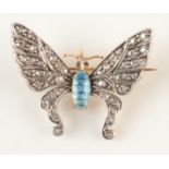 A gold butterfly brooch, each wing pave set with diamonds, the body blue enamelled,