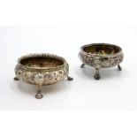 A Georgian open silver salt with gilt interior, floral decoration on three hoof feet,