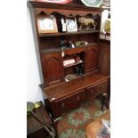 A George lll style oak dresser, the rack with a shaped apron,