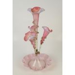 A white overlay cranberry glass epergne with four spills and petal shaped bowl base.