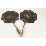 A pair of Victorian papier mache hand fans, with floral painted decoration and gilt turned handles,