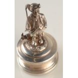 A contemporary silver paperweight in the form of the devil dressed as a golfer, height 6.8cm.