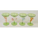 A suite of four Venetian green glasses, with shallow bowls, one with naked female support,