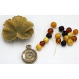 An amber bead bracelet, a gilt leaf brooch and a gold cased fob watch.
