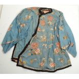 A Chinese blue silk robe, embroidered with floral sprays and stylized moths, length 104cm.