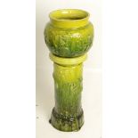 A Bretby pottery green glazed jardiniere and stand, each moulded in relief with dragons,