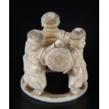 A Japanese ivory okimono, Meiji period, of four water carrier boys, height 3cm, diameter 3cm.
