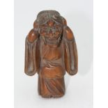 A Japanese carved wood okimono figure of a boy wearing a Hannya Noh mask, 19th century, signed,
