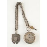 A Victorian engraved silver cased keyless fob watch with silver curb link chain and silver fobs.