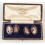A pair of engraved and enamelled gold cuff-links showing eastern deities, tests as 14/18ct gold, 15.