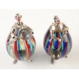 A pair of Italian sculptural figures in silver and Venetian glass, each is in the form of a clown,