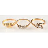 A gold ring crossover set with three diamonds,