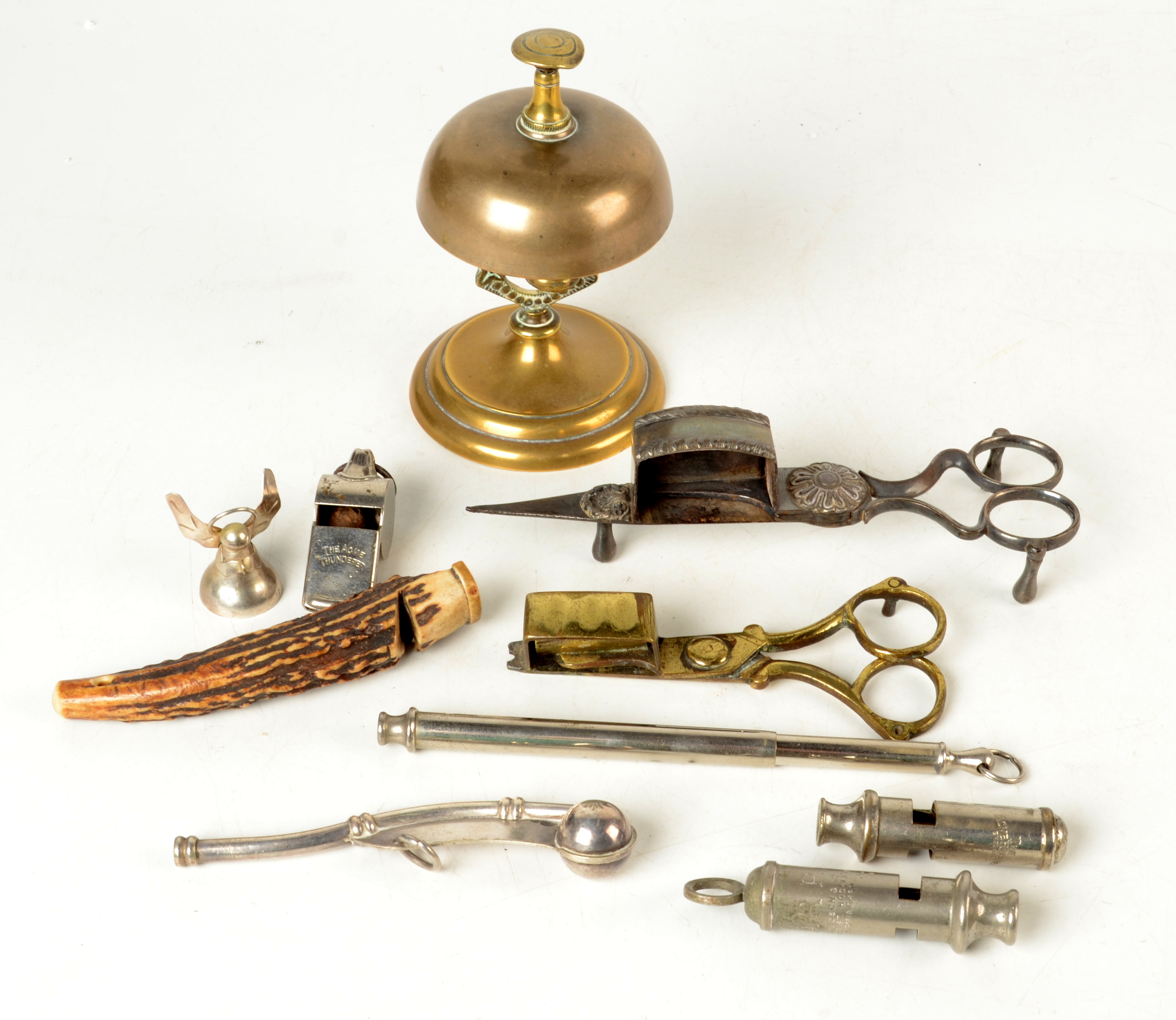 A brass servants bell, collection of whistles and two pairs of candle snuffers.