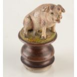 A cold painted bronze seated pig mounted as a seal, 4cm.