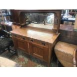 An Arts and Crafts oak mirror back sideboard,