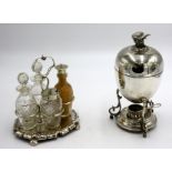 An EPNS egg coddler with bird finial and an oval shaped cruet with four cut glass bottles.