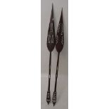 A pair of African carved hardwood decorative spears, lengths 168.5cm and 173cm.