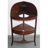 A mahogany corner washstand, early 19th century.