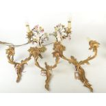 Three gilt metal wall sconces and a pair of gilt metal and porcelain figural table lights.