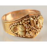 A Californian gold ring with applied vine leaves and beading, marked 18ct, 7g.