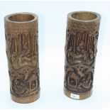 A pair of Chinese bamboo brush pots, each carved with figures, trees and a pagoda, height 35cm,