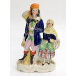 An early Victorian Staffordshire group of a fisherman and his wife, height 29cm.
