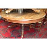 A Victorian mahogany extending dining table, the oval top on twin pedestals, one extra leaf.