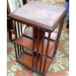 An inlaid mahogany revolving bookcase, early 20th century, with a square moulded inlaid top,