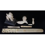 A Chinese ivory letter opener, 19th century, carved with a mother and child, length 29.2cm, width 3.