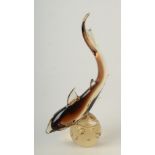 A Murano smoke glass shark balanced on a glass sphere with bubble inclusions, height 41.5cm.