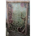 A coloured and leaded glass window decorated with stylised tulips in Art Nouveau taste, 122 x 79cm.