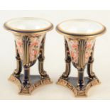 A pair of Derby Japan pattern tripod urns, dated 1914, height 12 cm.