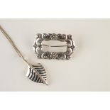 A Viking longship silver bow pendant and a Danish silver brooch.
