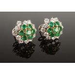 A pair of striking diamond and emerald cluster earrings set in high purity white and yellow gold,