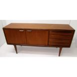 A G-Plan sideboard, with a pair of cupboard doors and four short drawers, on square tapering legs,
