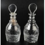 A pair of Georgian style cut glass decanters, height 24cm including flat lozenge stoppers.