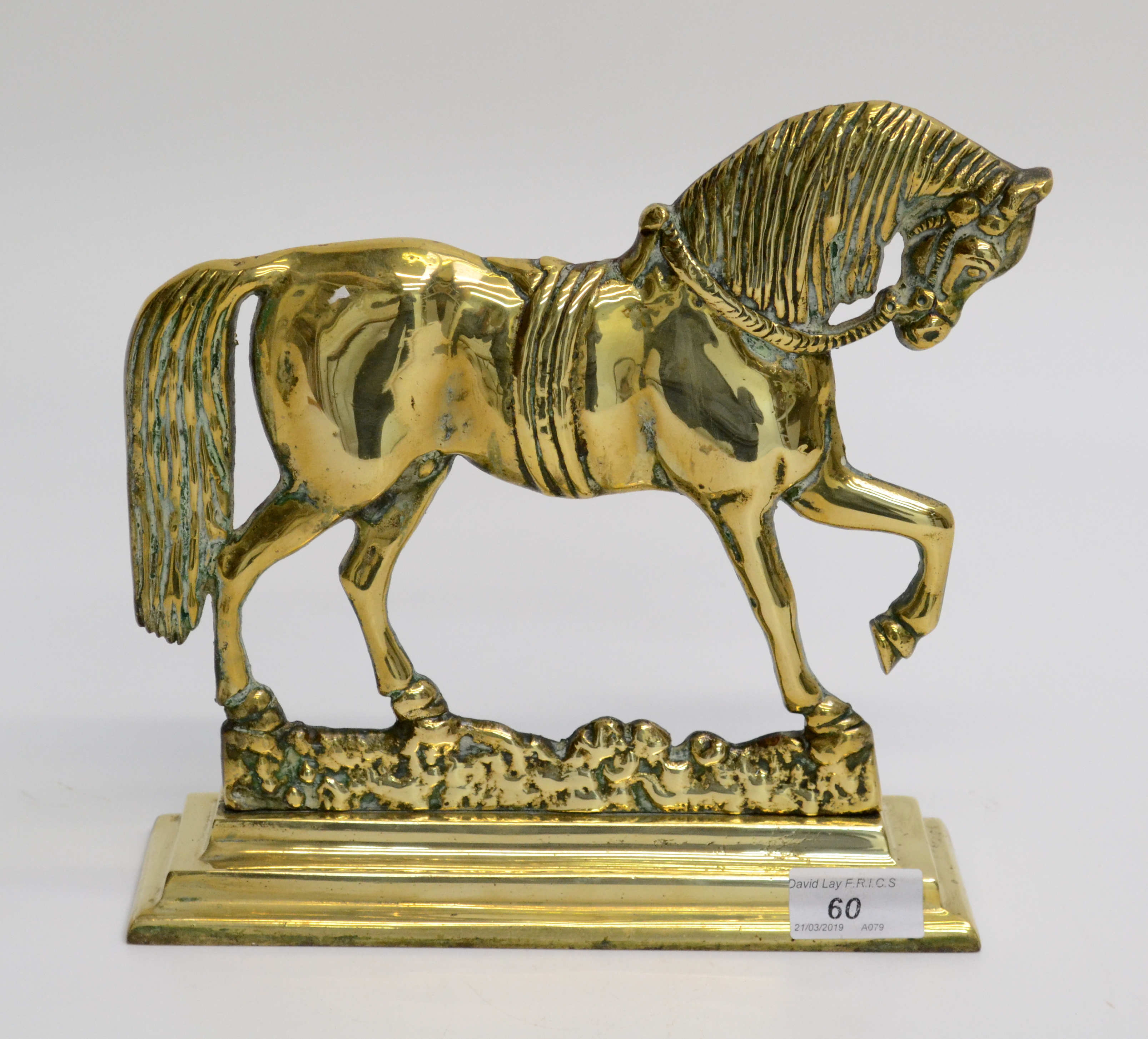 A brass doorstop in the form of a horse, early 20th century, height 24cm, width 24.5cm.