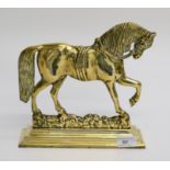 A brass doorstop in the form of a horse, early 20th century, height 24cm, width 24.5cm.