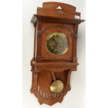 An Arts and Crafts Ernst Bock mahogany wall clock, the 18cm brass dial with arabic numerals,