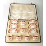 A set of six Royal Crown Derby porcelain coffee cans and saucers, in original leather case,