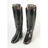 A pair of gentleman's black leather riding boots, with trees.