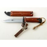 A bayonet, in a brown bakelite scabbard, length 27.5cm.