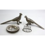 Two pheasant table ornaments, a pair of fluted dishes, a toast rack and a pair of tongs.