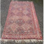 A Khamseh carpet, South West Persia, the indigo field with eight linked ivory medallions,