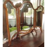 A carved triple fold dressing table mirror, height 89cm, width 110cm.
