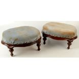 A pair of Victorian mahogany oval footstools, each with a padded seat on turned tapering legs,